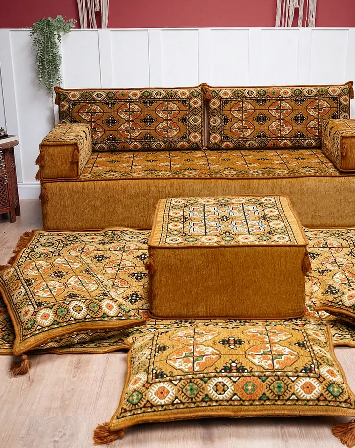 Gold Afghan Gul single floor sofa with octagonal medallion backrests, a square ottoman and floor pillows between carved wooden screens
