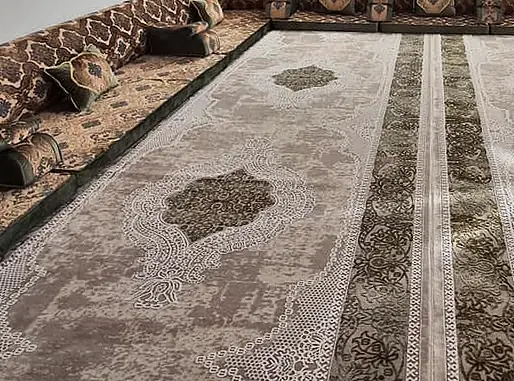 Bronze and olive majlis along three walls with damask-patterned back panels, matching seat fronts and tables in the centre