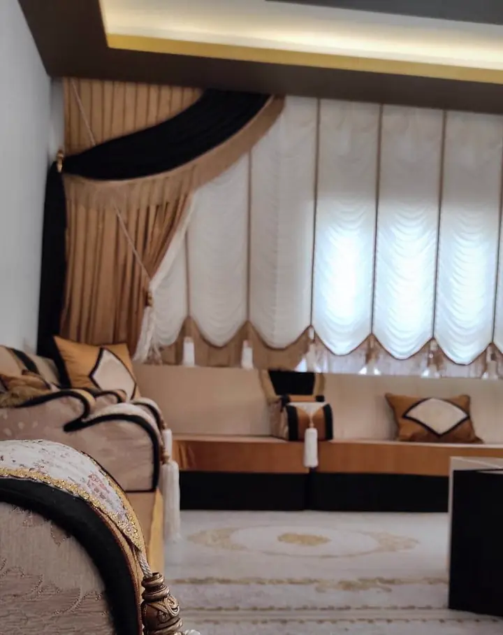 Champagne majlis with black and caramel base bands, diamond-panel cushions, white tassels and ivory festoon blinds
