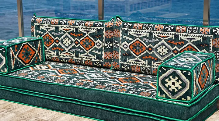 Green kilim single floor sofa on a thick two-layer seat with square cube armrests and matching backrests outdoors