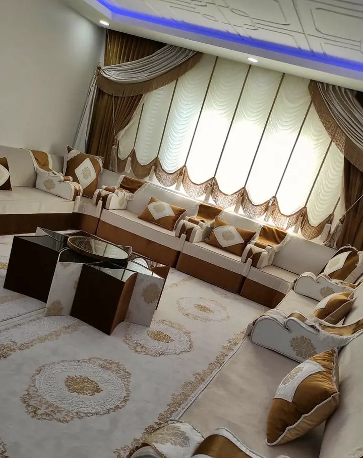 Ivory floor majlis with mustard-gold bands and diamond cushions around a star-shaped table, on a cream rug with gold medallions