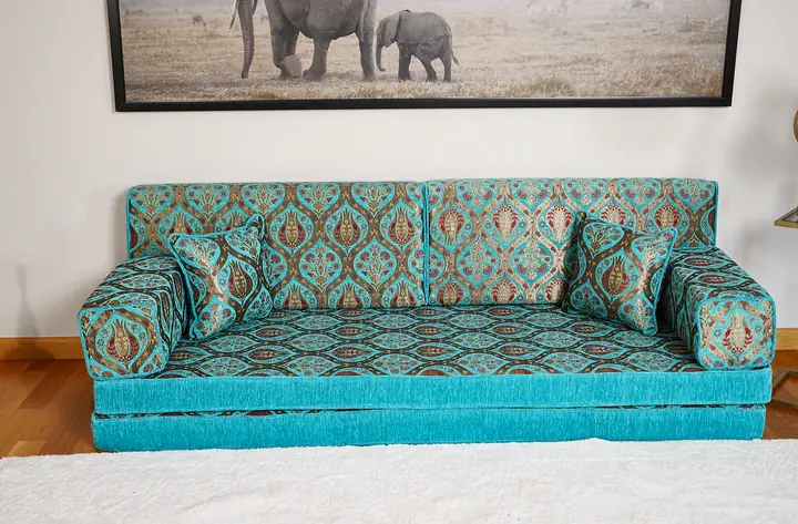 Front view of a turquoise tulip floor sofa raised on a stacked base, giving a higher seat than the floor version