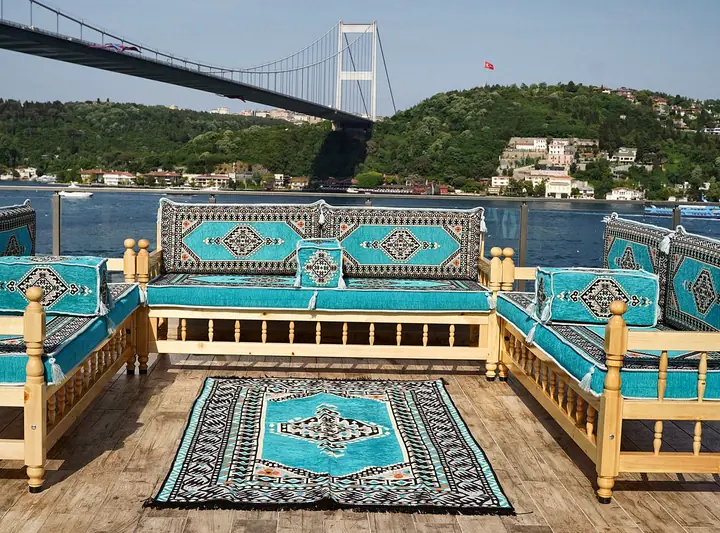 Turquoise medallion seating on three raised wooden benches, with a matching rug filling the space between them
